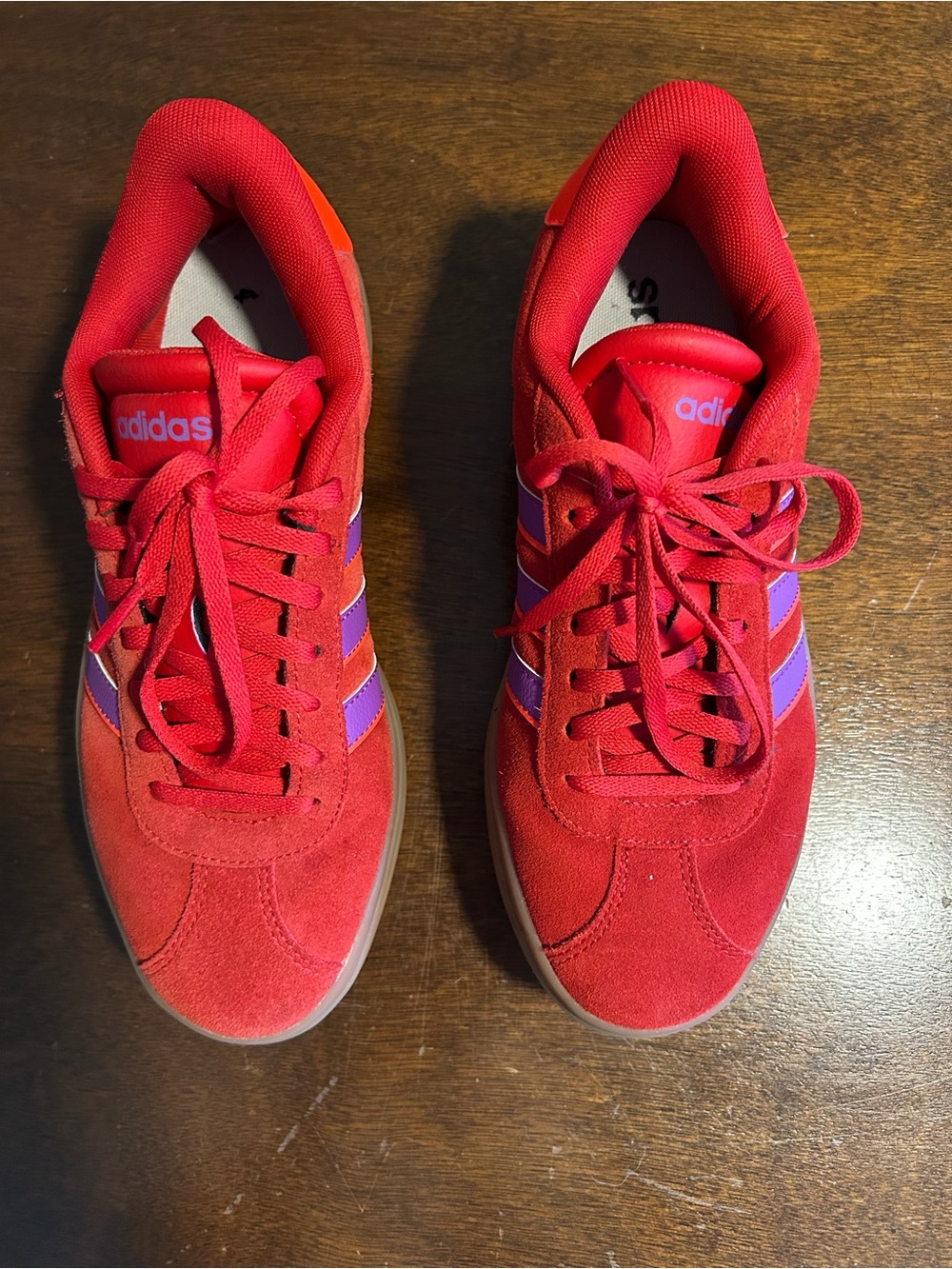 Adidas women’s red suede sneakers.
